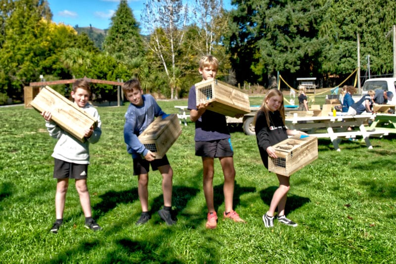 Four Year 7 and 8 students from Ngatimoti School hold the predator traps they've built.